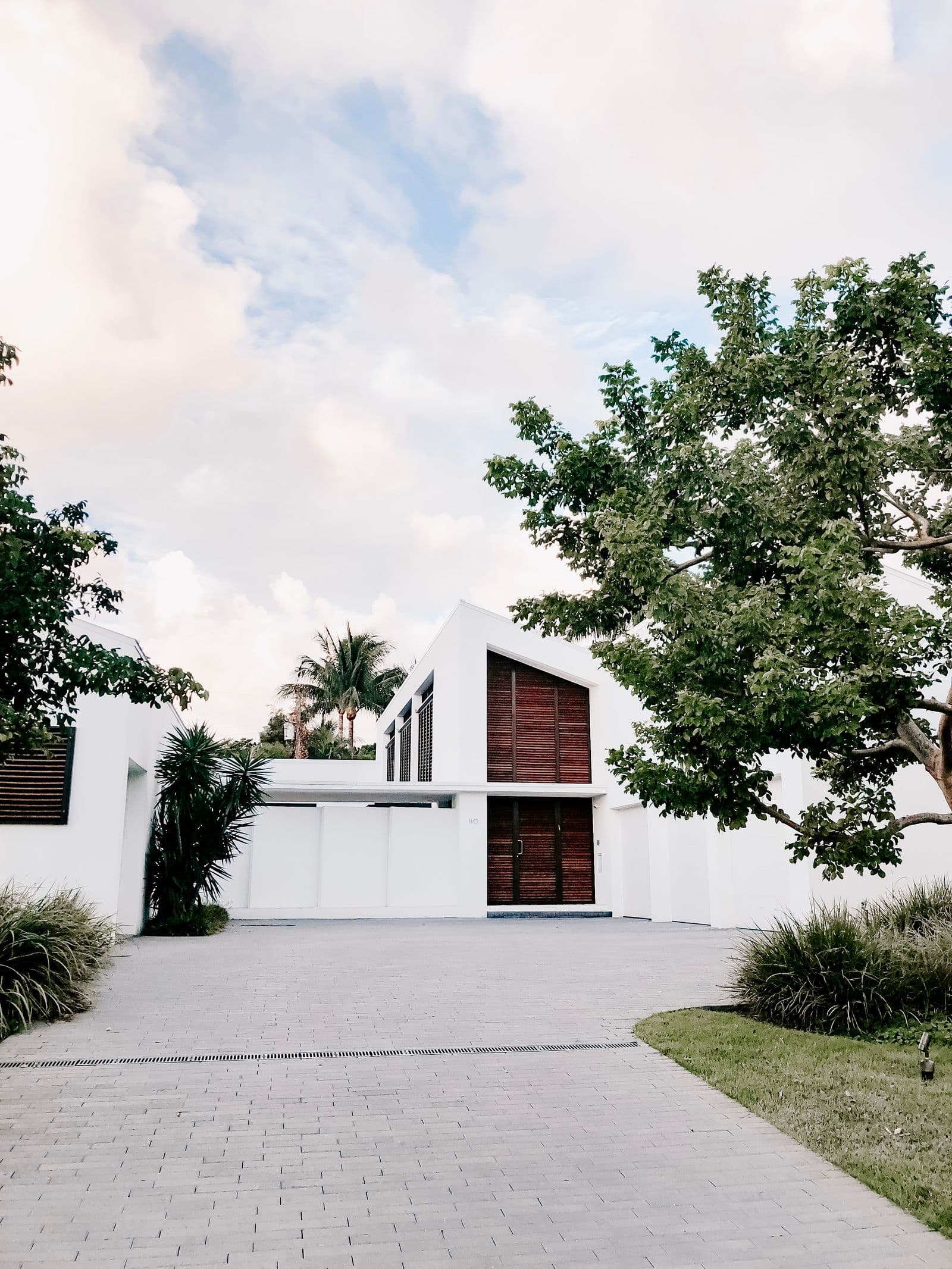 Modern white house with landscaped driveway