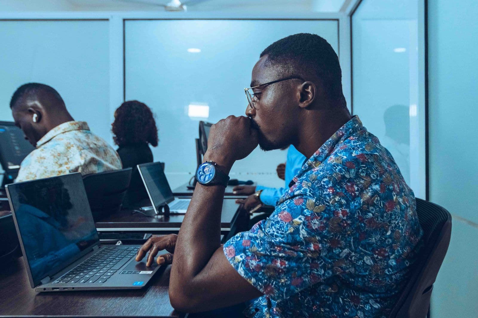 Developers working on laptops in an IT workshop in Accra
