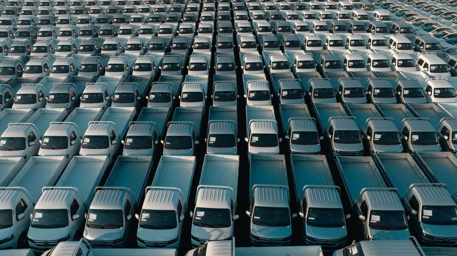 Aerial view of a large fleet of pickup trucks in rows